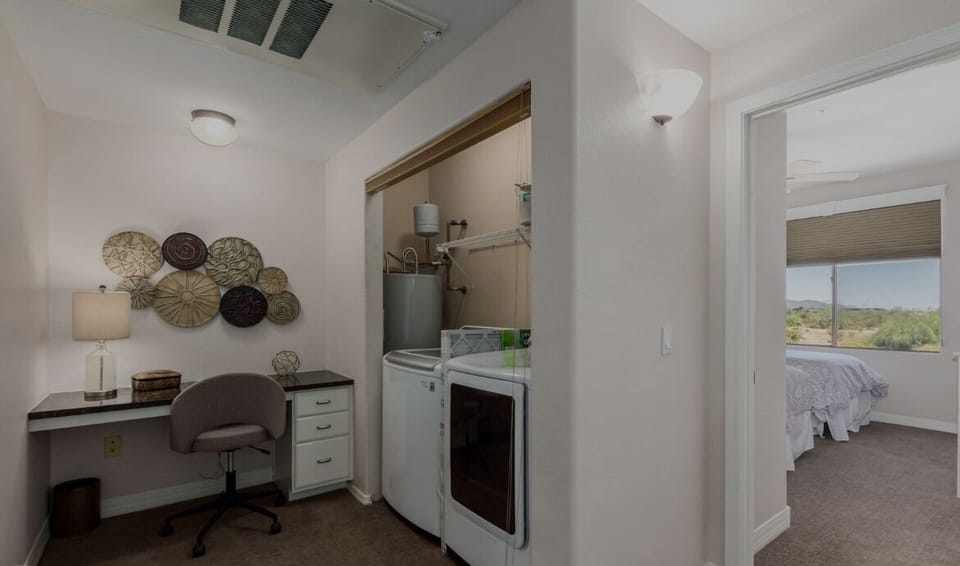 Dedicated workspace and in unit washer and dryer located next to second bedroom