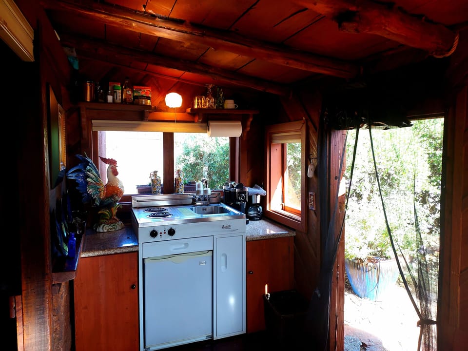 Kitchenette that includes fridge and 2 burners., pots, pans, dishes & utensils.