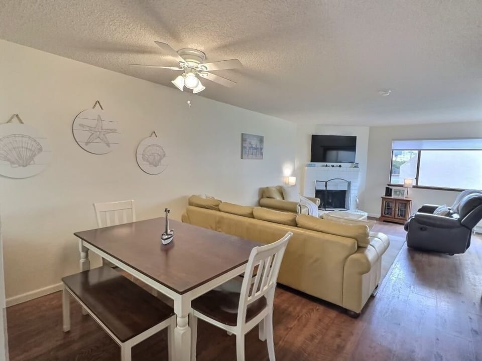 The dining area comfortably seats six guests, perfect for enjoying meals or a game of cards or board games after a day at the beach.