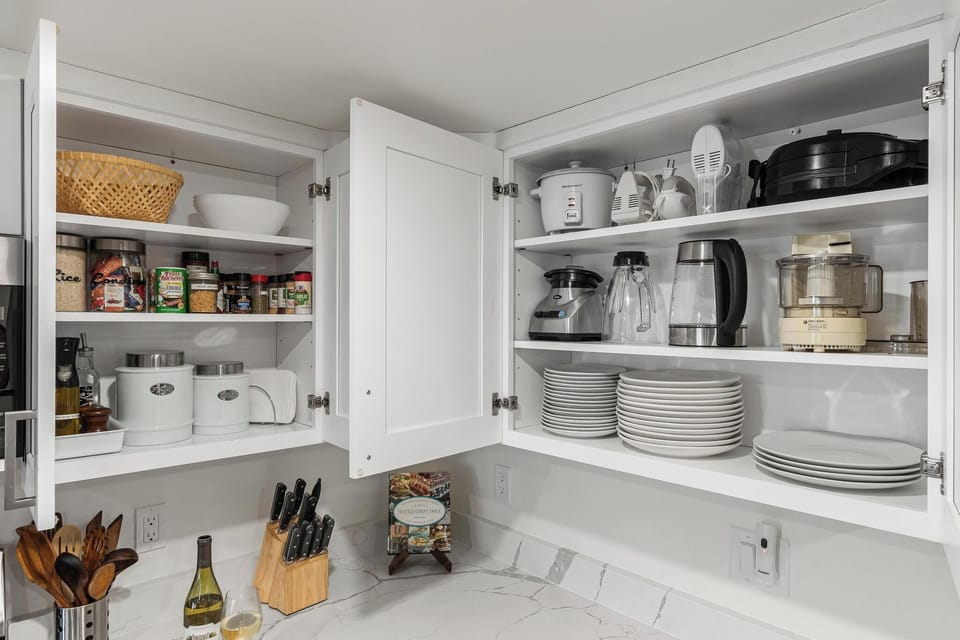 - Kitchen cabinets stocked with cookware dishes and essentials  
- Appliances including coffee maker blender and toaster  
- Ready for extended stays with everything needed to cook  
