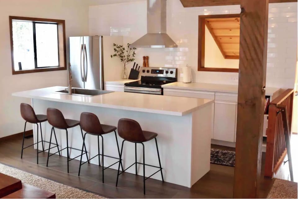 Crisp and functional kitchen stocked with dishes and cooking essentials.