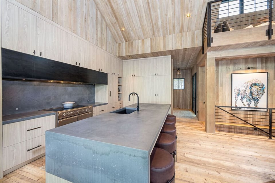 The beautifully appointed and fully equipped kitchen features high-end appliances and incredible custom cabinetry.