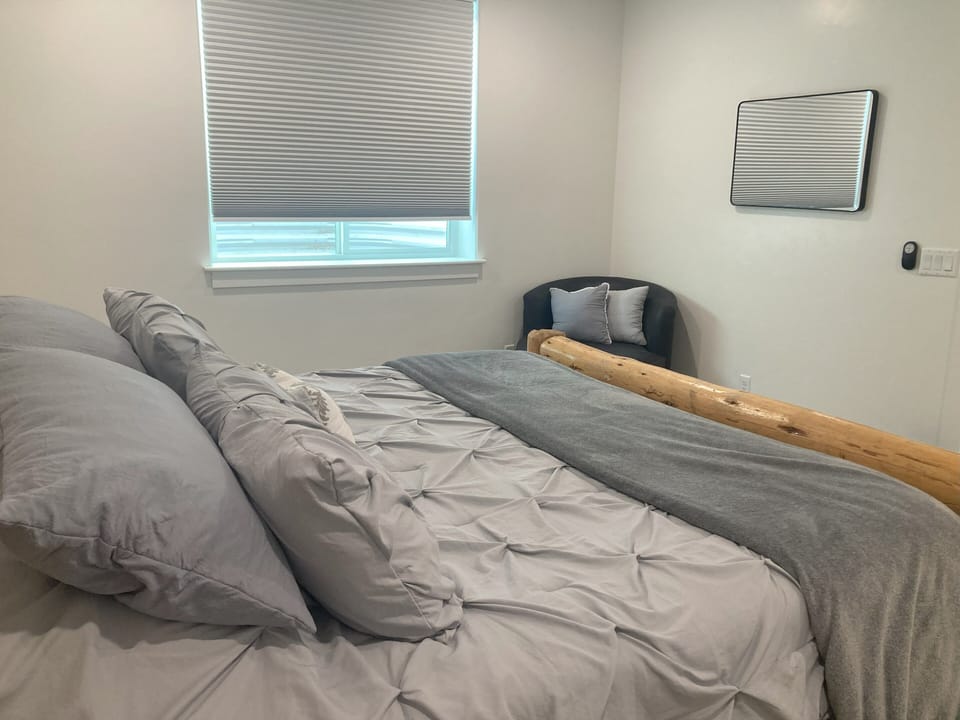 Bedroom with large window and comfy chair