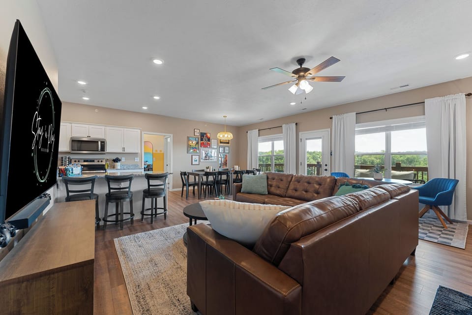 Upstairs living room holds a 75" TV with a Nintendo Switch.