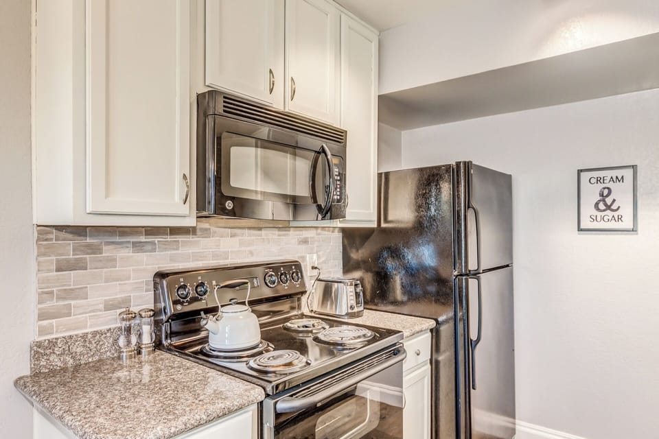 Full kitchen provides all of the essentials such as coffee, toaster, teapot, etc