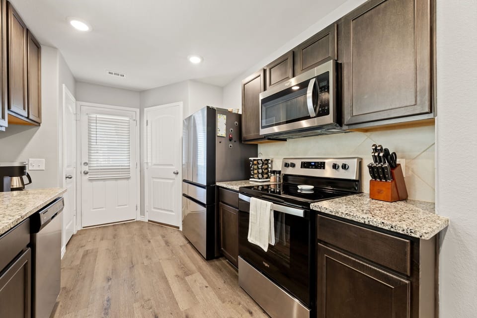 Kitchen with new appliances with well stocked kitchen for making great meals.