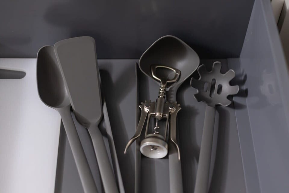 A close-up view of stylish kitchen utensils hanging neatly. Functional and well-organized.