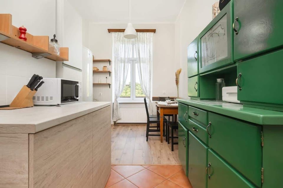 Separate kitchen with dining table and chairs.