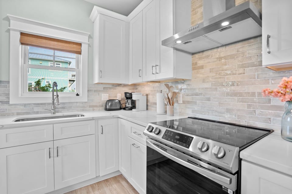  Main Kitchen Area w/ Stainless Steel Refrigerator, Oven & Range, Microwave, Dishwasher,  Spacious Island w/ Modern Finishes, and Breakfast Bar