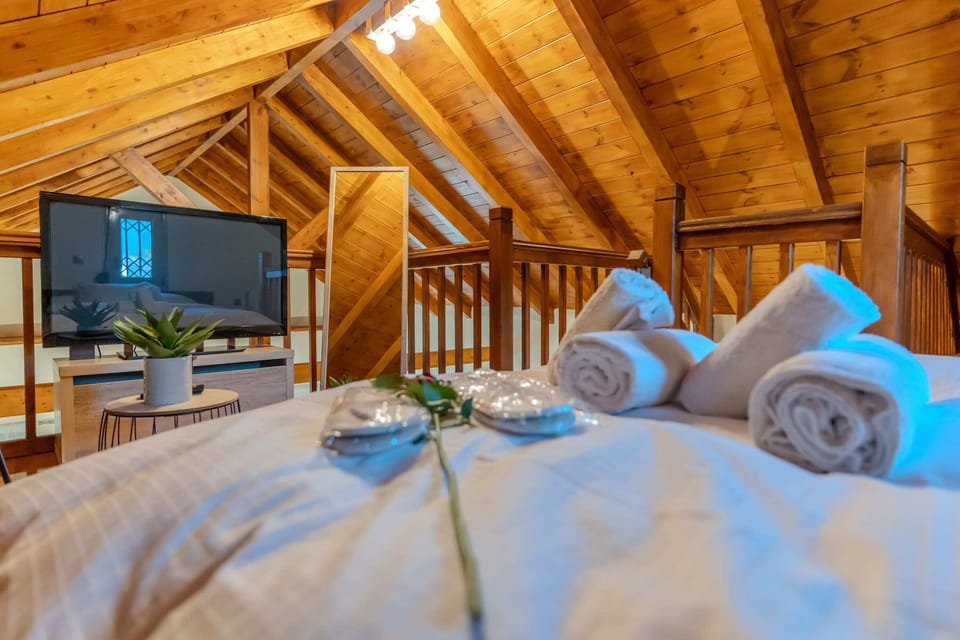 Sleeping Area in the Attic – A cozy hideaway with wooden accents and ambient light.