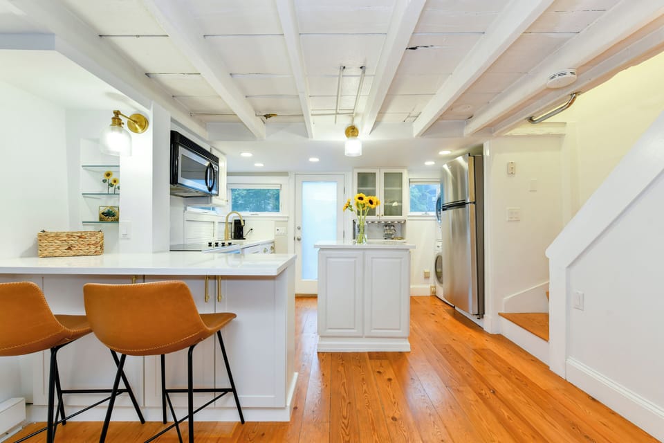 Living room and kitchen area with peninsula bar area.
