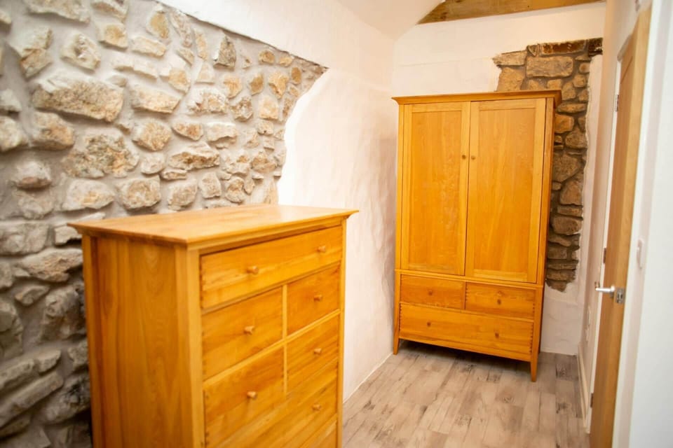 King size bedroom with chest of drawers and double wardrobe