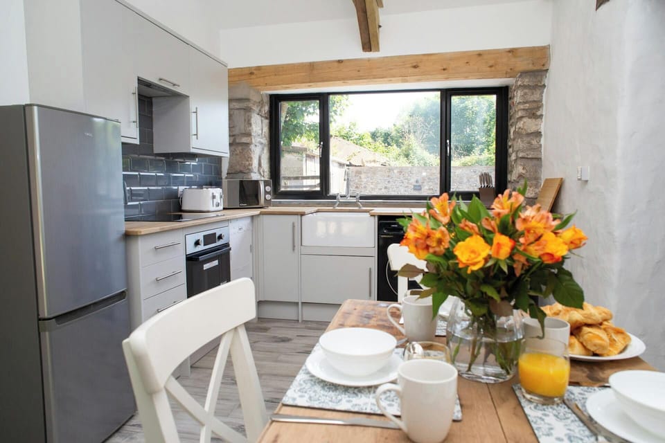 Kitchen with fridge freezer, oven and hob. Views over the garden
