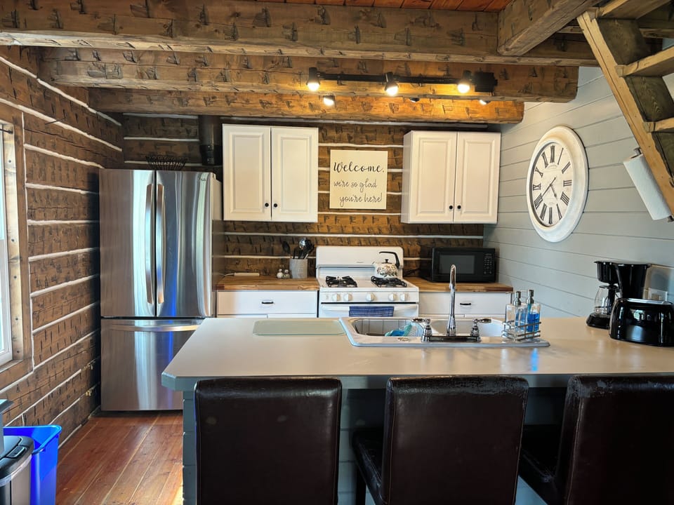 Kitchen refrigerator, stove, microwave, coffee pot, toaster and double sink