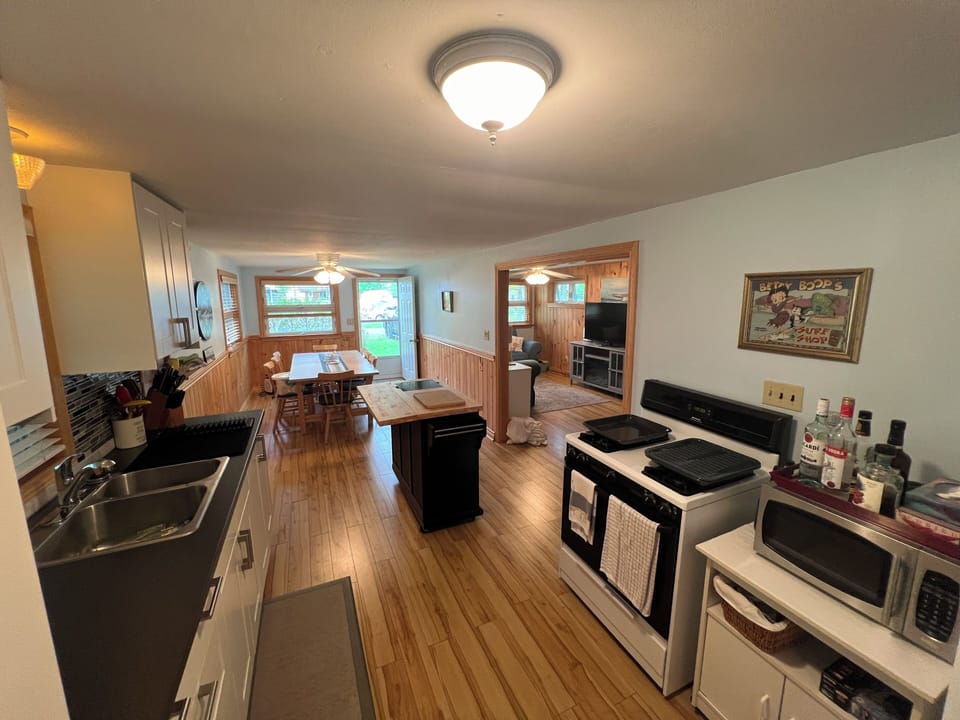 Updated kitchen w fridge, microwave and gas stove