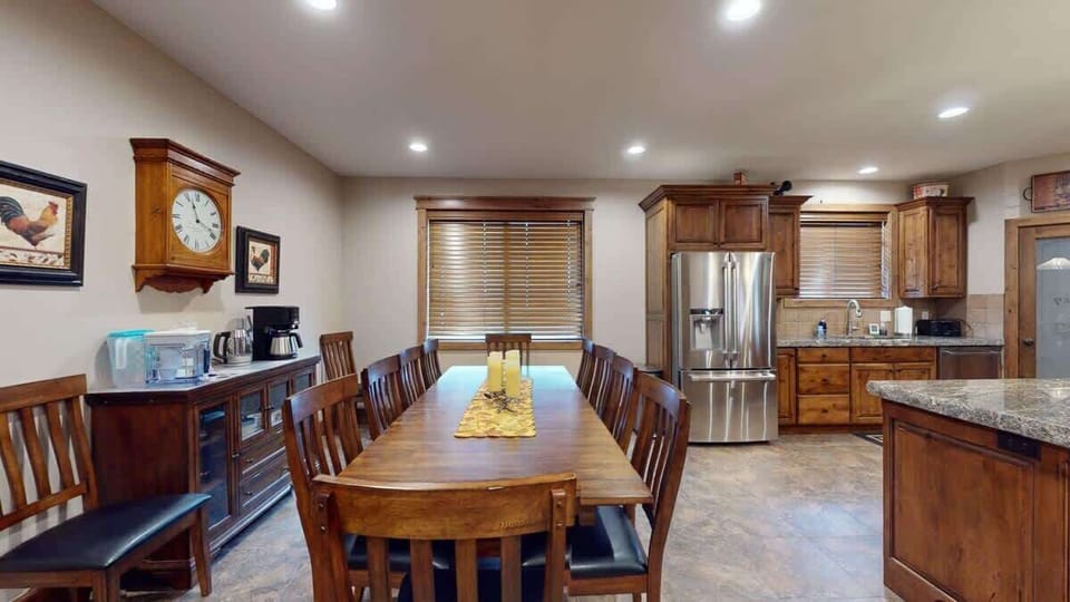 Dining room table located adjacent to the kitchen with space for everyone.