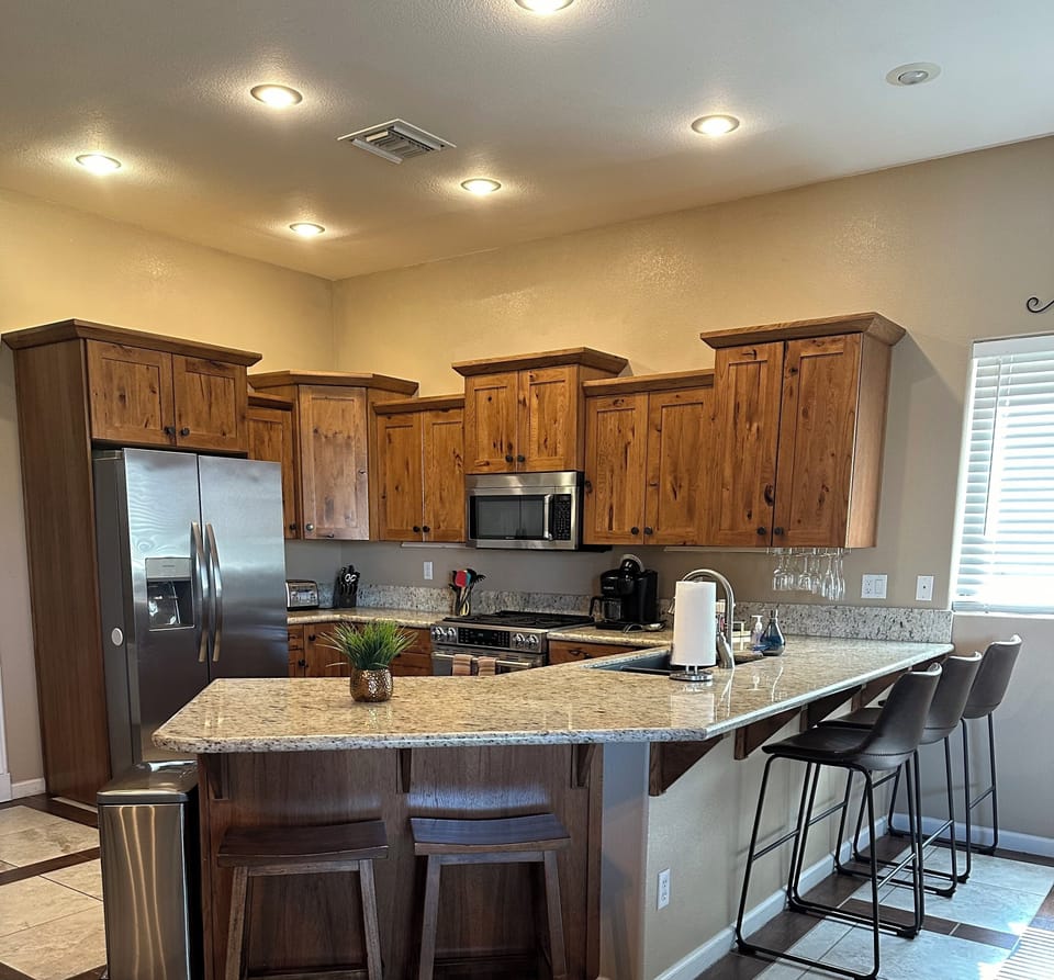 Kitchen bar with plenty of seating for 6+.