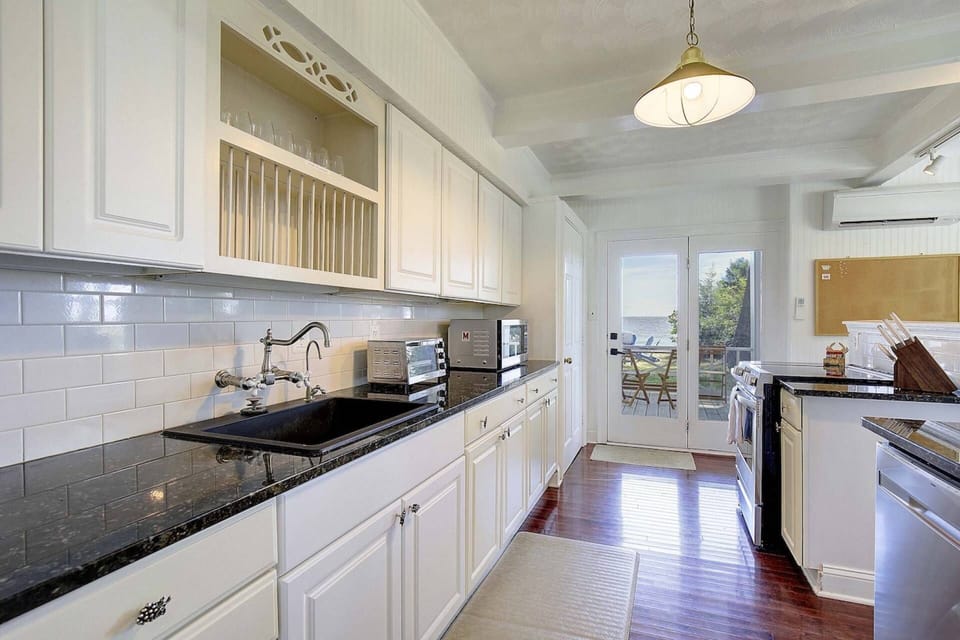 The updated kitchen is ready for your stay with plenty of cookware and dinnerware.