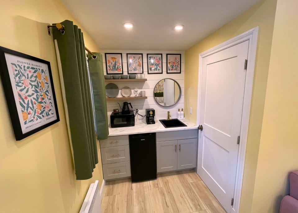 Adorable kitchenette with tasteful dinnerware perfect for light meals.  