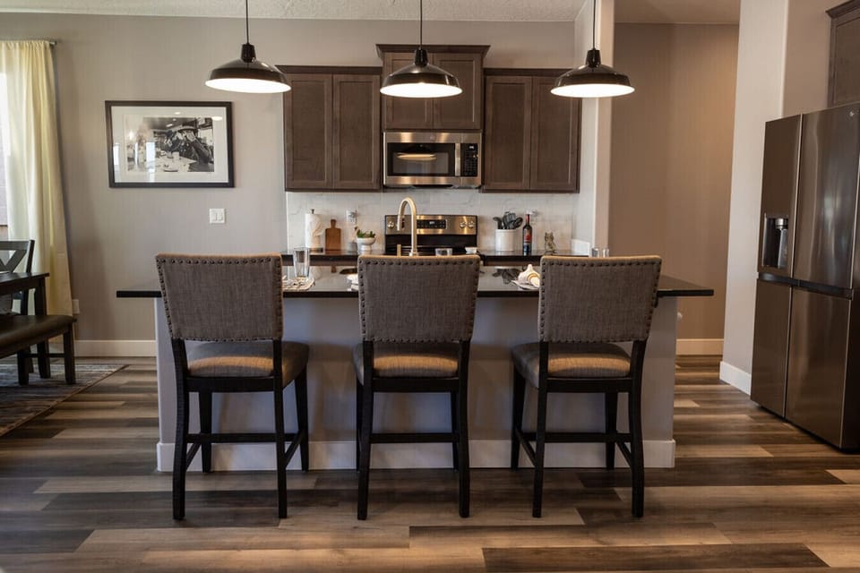 Beautiful kitchen and kitchen bar offers additional seating.