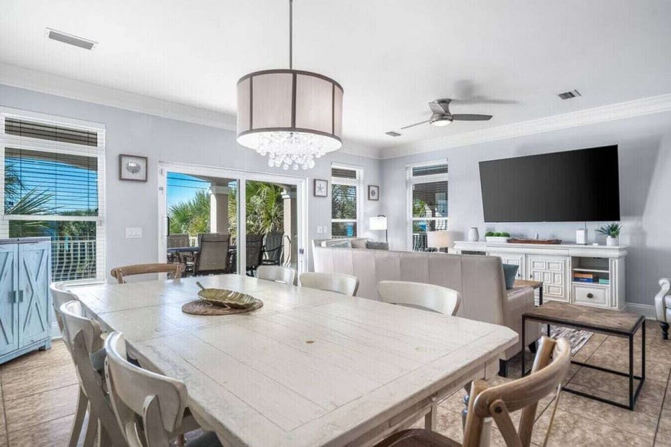 Gather around this spacious dining table where your group can share meals and make memories in this beautifully appointed open-concept space.