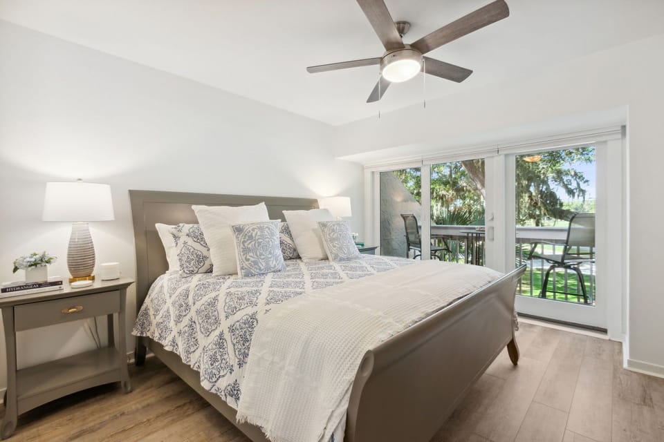 Unwind in the Master Bedroom Suite with Private Balcony, Gorgeous Golf Course and Lakeside Views, and a Flat Screen Smart TV (King Bed)