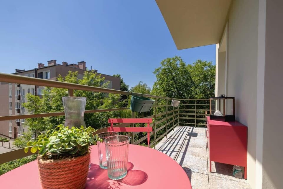 Furnished balcony with green surroundings. 