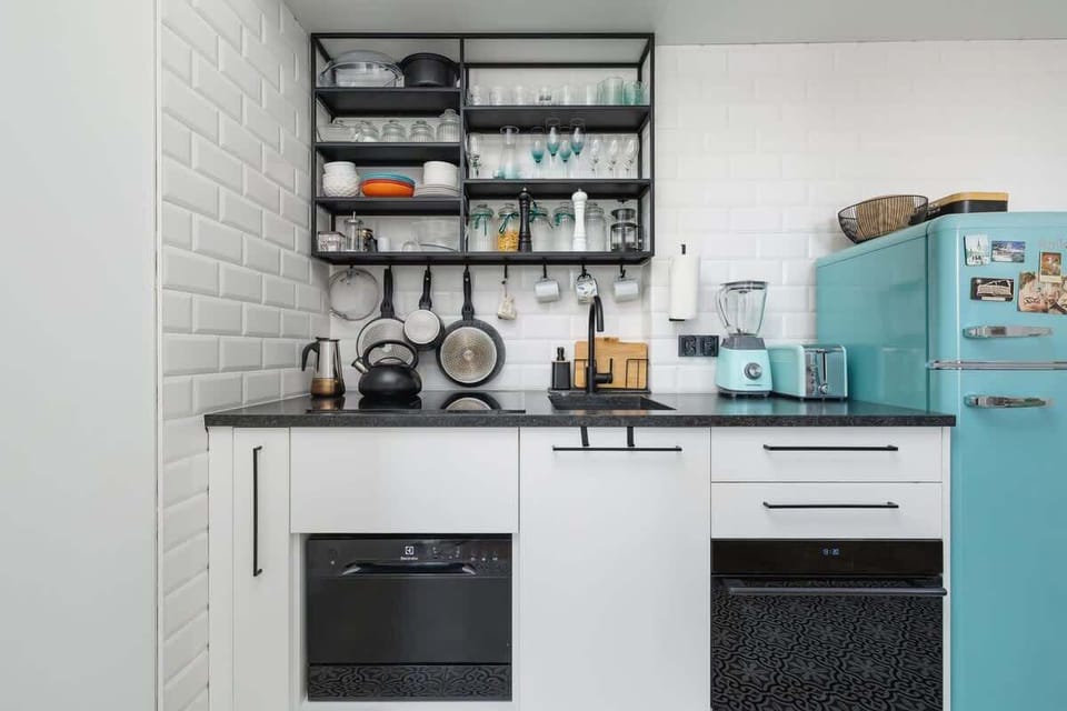 Kitchenette with oven and refrigerator. 