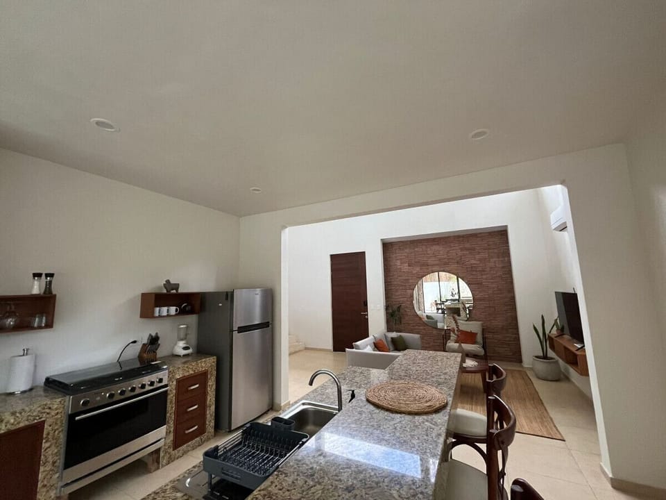 Unleash your inner chef in our luxurious Tulum villa kitchen, complete with an oven, dishwasher, and all the essentials for gourmet adventures