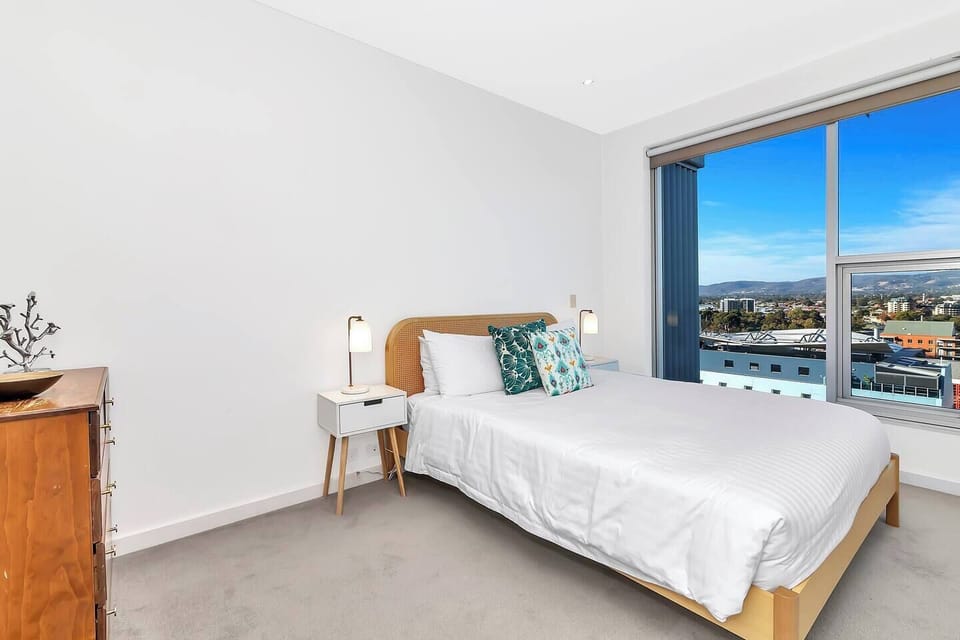 The primary bedroom captures vistas over the city and comes with a private ensuite bathroom.
