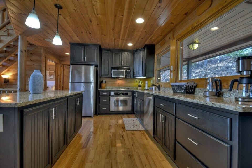 Fully equipped kitchen on the main level with open bar seating, perfect for entertaining and enjoying the beautiful views from the deck.