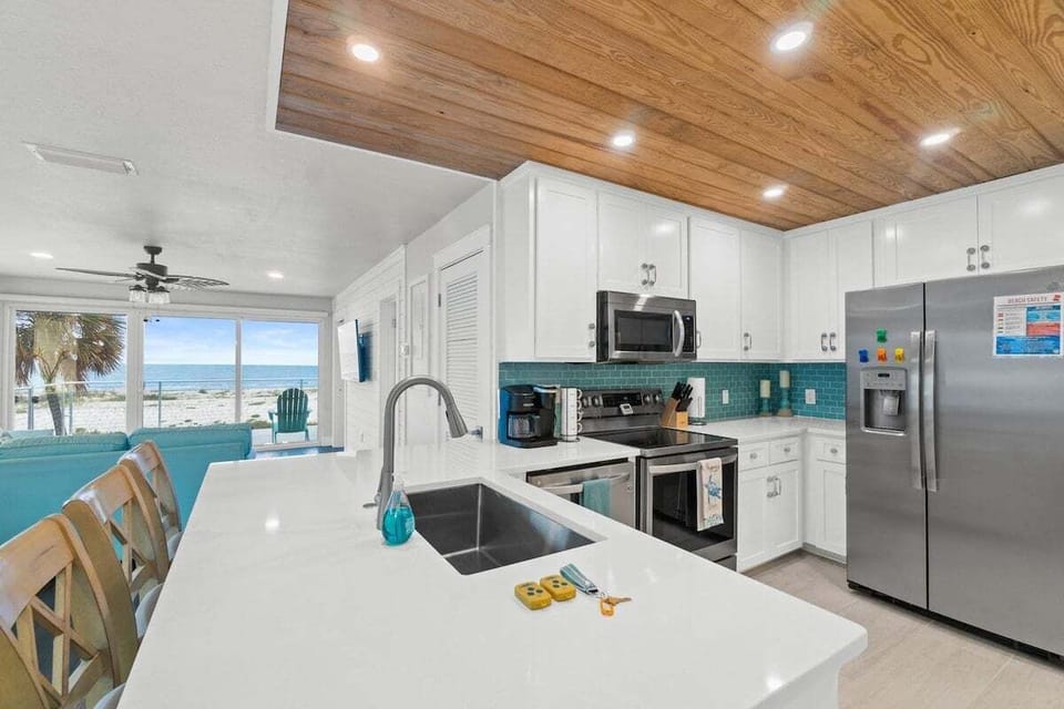 Pristine kitchen with stainless steel appliances and a Keurig + Drip coffee machine.