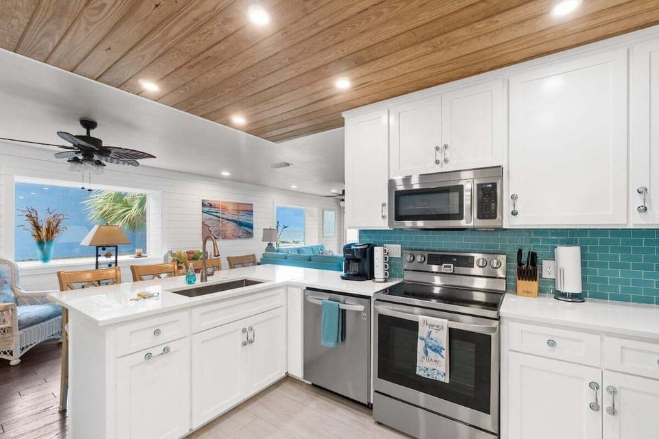 Pristine kitchen with stainless steel appliances and a Keurig + Drip coffee machine.