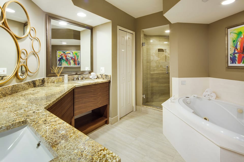 Refresh in a spa-like bath with soaking tub and glass shower.
