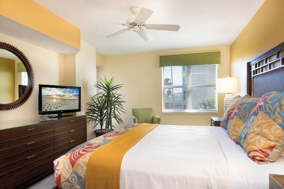 Unwind in crisp linens with soothing sunshine and ceiling fan.