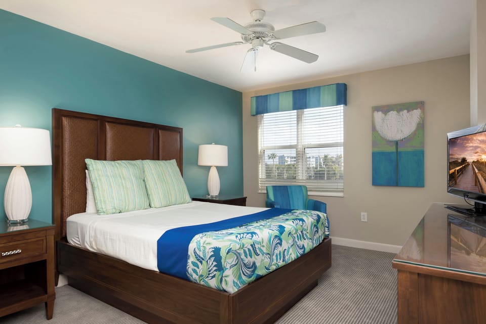 Stretch out comfortably in a serene bedroom with soft lighting.