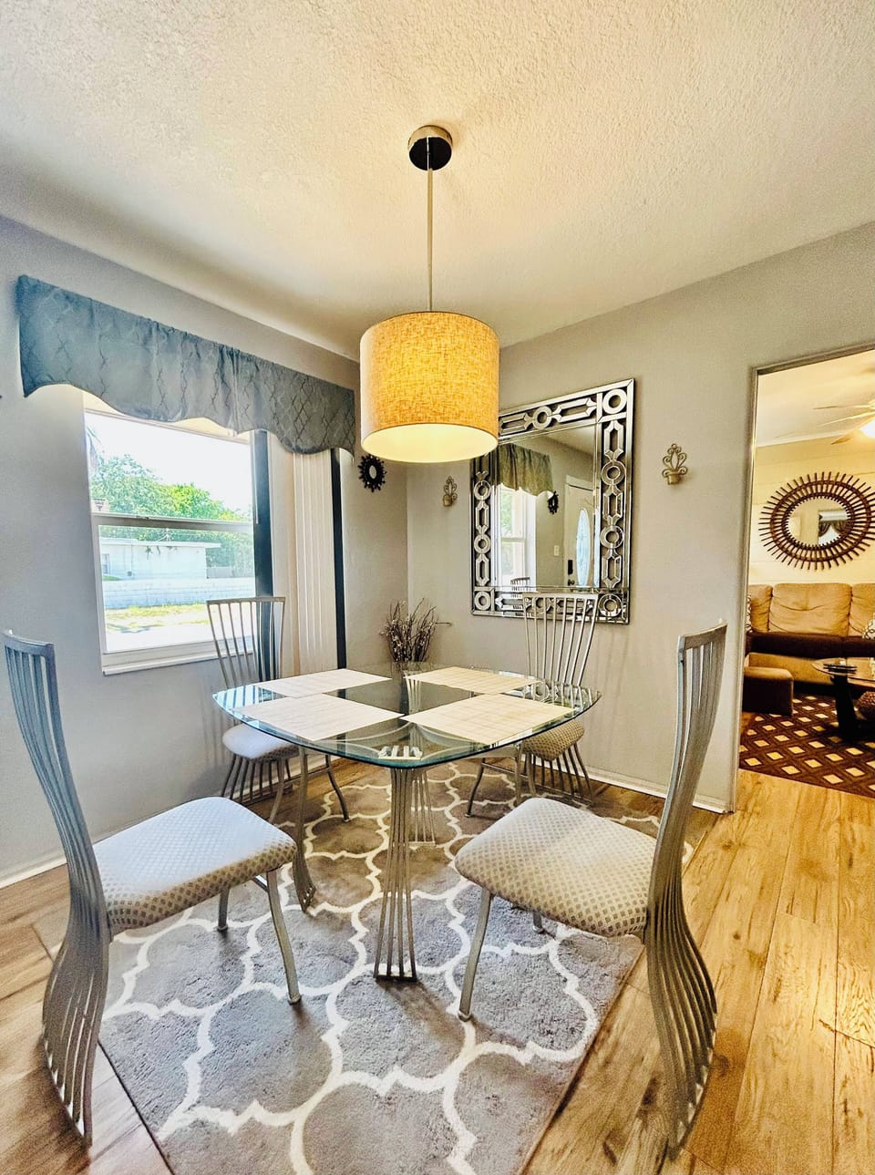 Our open concept living & dining area with a ceiling fan, sofa and dining table