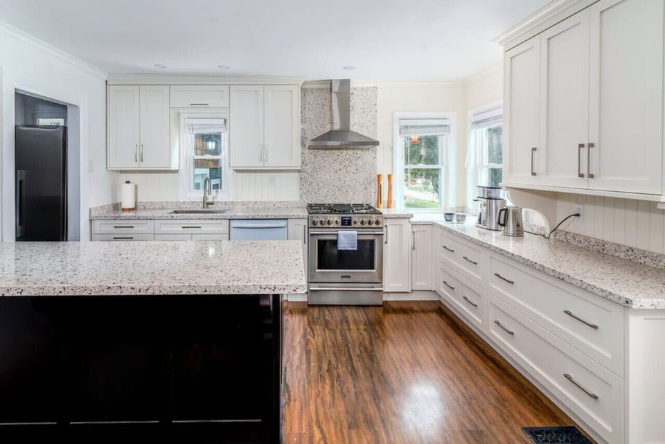 Kitchen with all cooking essentials, gas range, coffee machine, toaster, microwave, spices, coffee, tea, sugar, cooking oil, salt and pepper