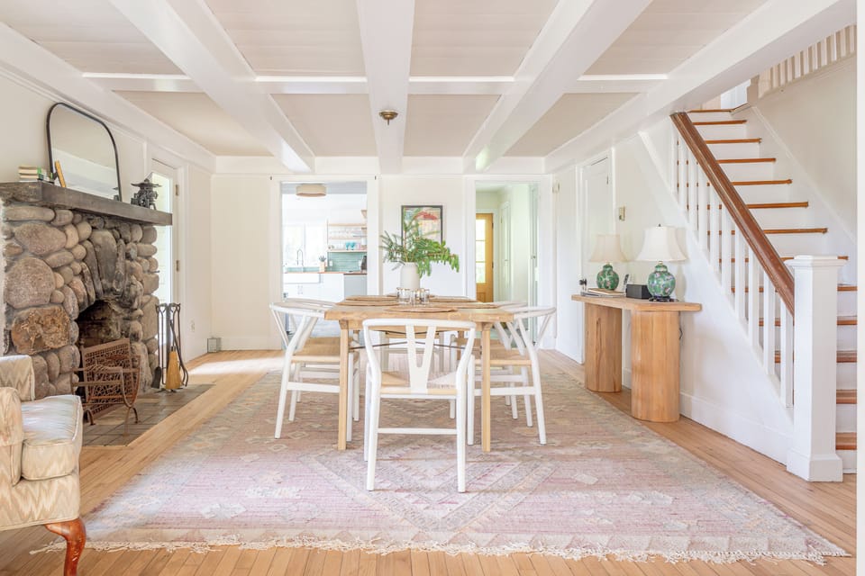The formal dining room features a fieldstone wood-burning fireplace (non-operational) and seating for six. 