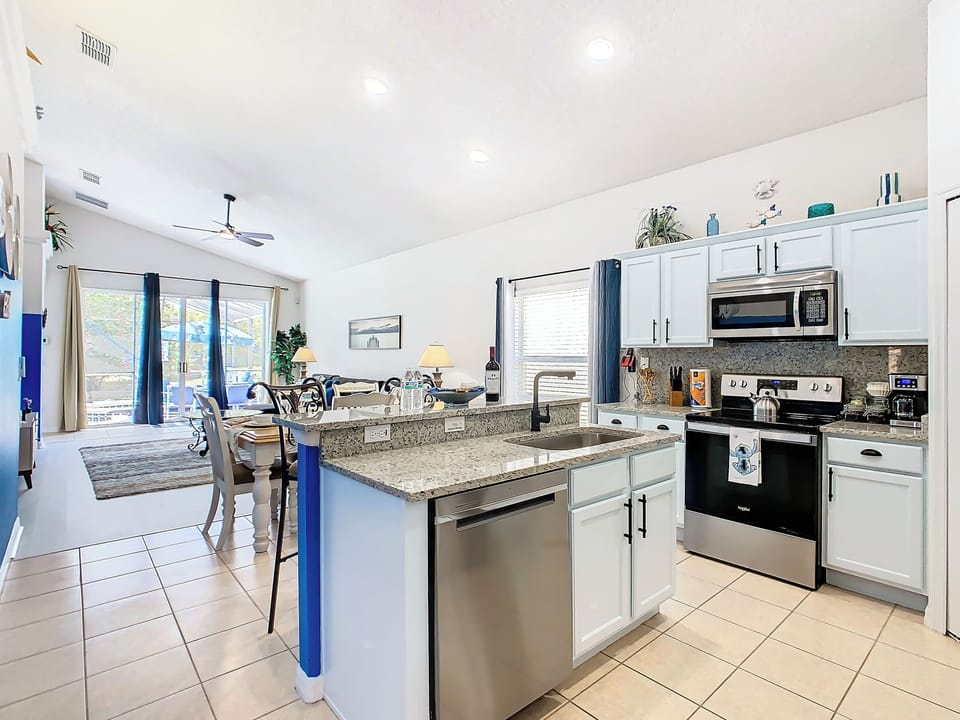 - Fully equipped kitchen with granite countertops and stainless steel appliances
- Extra storage, modern lighting, and bar seating make cooking and gathering a joy
- Overlooks the dining and living area with views toward the patio and pool