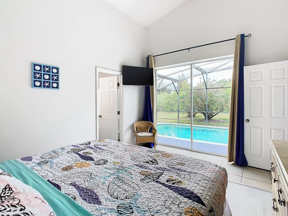 - Wake up to serene views with direct access to the screened in private pool
- Cozy coastal bedding and a mounted smart TV make this a perfect place to unwind
- Bright, airy design with double curtains for light control and privacy