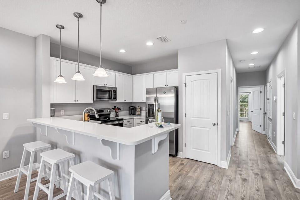 Your bright modern kitchen awaits with sleek white cabinets, stainless appliances, and a spacious breakfast bar where you'll love starting each morning.