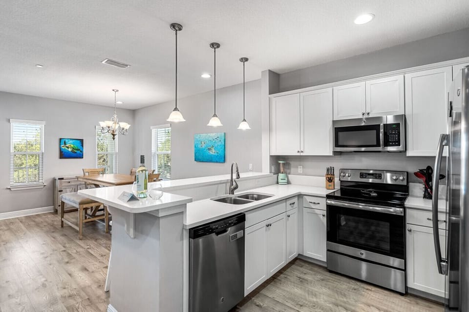 Your fully equipped kitchen awaits with modern appliances, spacious countertops, and a breakfast bar where you can start each morning right.