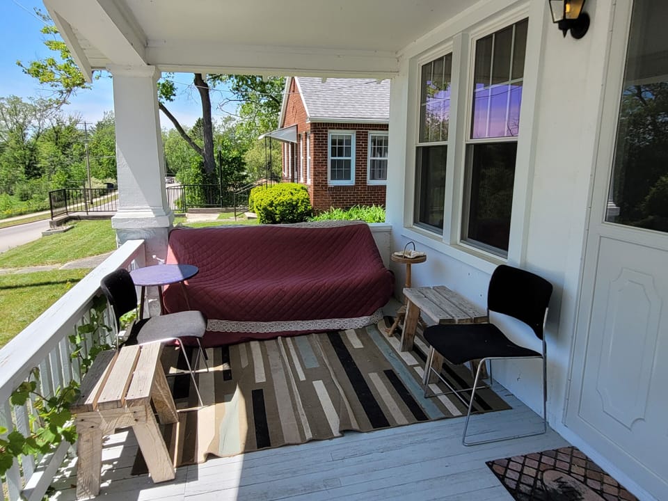 EXTERIOR:  The cozy front porch, which faces south towards the Au Sable River