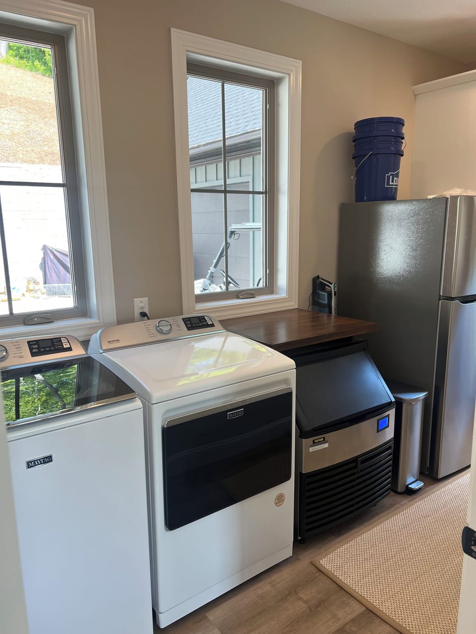 Laundry room, commercial ice maker, and second fridge.
