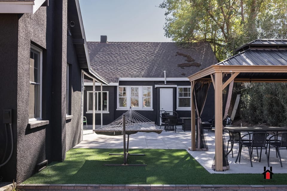 Our backyard offers covered dining, BBQ, a fire pit lounge & hammocks