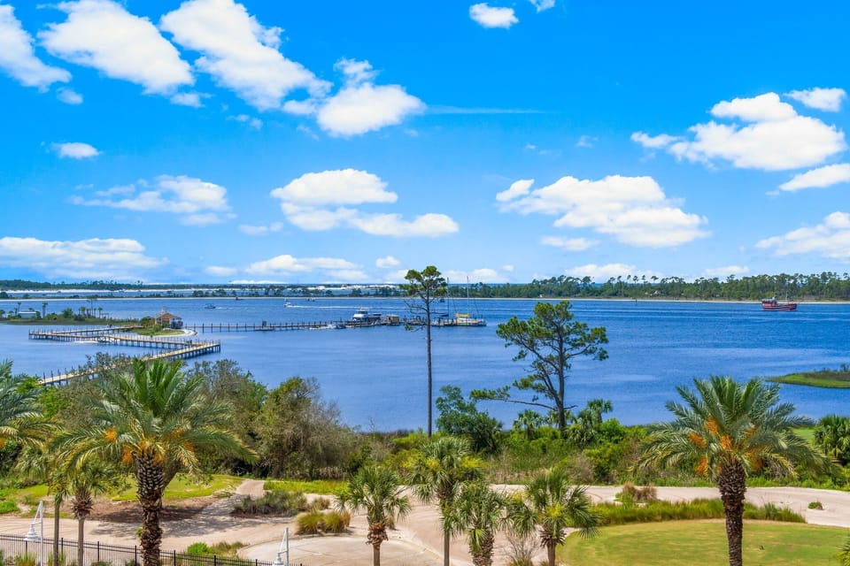Step onto your spacious private balcony overlooking the resort style swimming pool, Grand Lagoon, the Nicklaus designed golf course, the State Park, & Shell Island. You absolutely cannot beat this view!