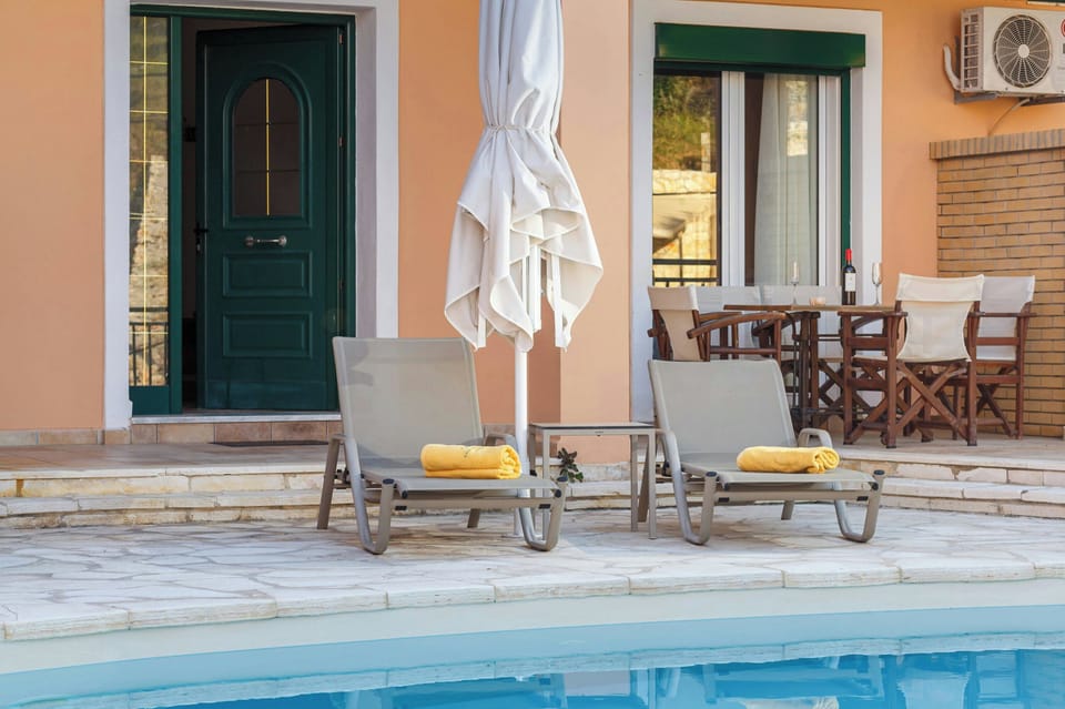 "Comfortable sunbeds by the poolside, perfect for soaking up the Corfiot sun."