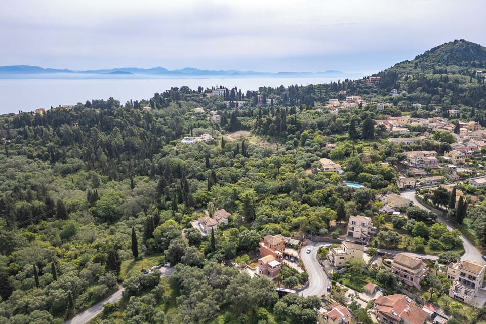 "Marvel at the seamless blend of nature and culture as you soar over our property, with the Achilleion Palace and Benitses village standing as neighbors amidst the verdant landscape of Gastouri. "
