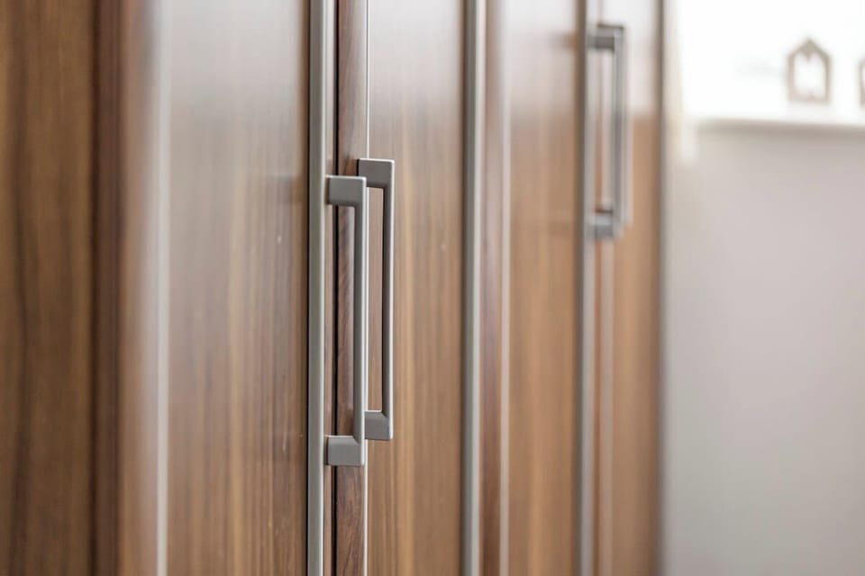 - Wooden wardrobe with sleek handles and ample storage  
- Perfect space to unpack and organize during your stay  
- Blends modern design with functional guest convenience  